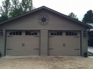 Sandtone Clopay Gallery long panel door with arch-1 and rectangular grille window