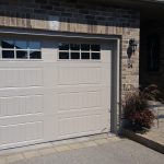 Sandtone Clopay Gallery door with elegant long panel and square 24 window inserts