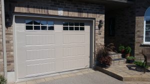 Sandtone Clopay Gallery door with elegant long panel and square 24 window inserts