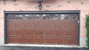 Walnut oak Clopay Gallery long panel with arch-3 and square grille standard hardware