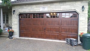 Walnut oak Clopay Gallery long panel with arched square grille window insert