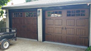 Walnut oak Clopay Gallery short panel door with square grille and #17 strap hardware