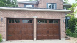 Walnut oak Clopay Gallery long panel door with rectangular grille and standard hardware