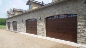 Walnut oak Clopay Gallery short panel door with step plate and handle hardware