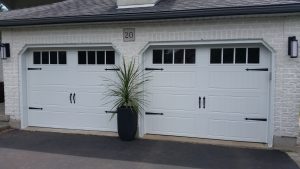 White Clopay Gallery long panel door with rectangular grille and standard hardware