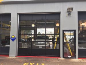 Clopay Modern Steel garage door with black aluminium frames and clear glass panels 2