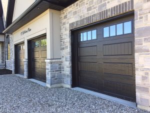 Black Clopay Classic door with elegant long panels and rectangular vertical grille window