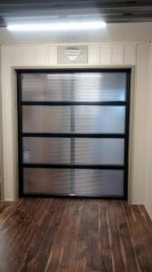 Clopay Modern Steel polycarbonate door with black frame and clear glass panels
