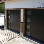 Black Clopay Modern Steel flush panel door with frosted window inserts