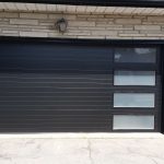 Black Clopay Modern Steel door with modern grooved panel and frosted long window inserts