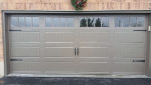 Bronze Clopay Gallery door with elegant long panel, arch-3 rect grille and standard hardware