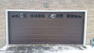 Chocolate Clopay Classic long panel door with arch-3 and vertical grille windows