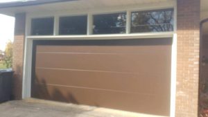 Chocolate brown Clopay Modern Steel garage door with flush panel design