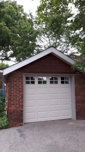 Desert tan Clopay Classic door, elegant short panel with square Suffolk grille window 1