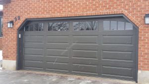 Mocha brown Clopay Classic door with elegant long panel and arch-3 rectangular grille