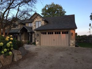 Sandtone Clopay Coachman carriage-house style garage door, available through WM Haws