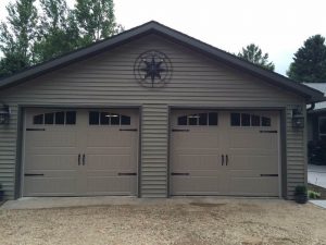 Sandtone Clopay Gallery door with elegant long panel and arch-1 rectangular grille