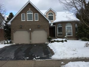 Sandtone Clopay Classic Collection garage door with elegant short panel design