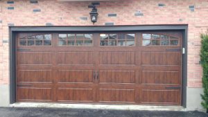 Walnut oak Clopay Gallery long panel door with arch-3 and square grille window