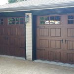 Walnut oak Clopay Gallery door with elegant short panel, square grille and #17 strap hardware