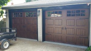 Walnut oak Clopay Gallery door with elegant short panel, square grille and #17 strap hardware