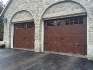 Walnut oak Clopay Gallery door, elegant short panel with square grille and decorative strap hardware