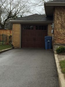 Walnut oak Clopay Gallery door, elegant short panel with square grille and standard handles