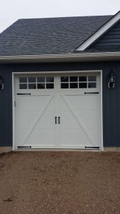 White Clopay Coachman carriage-house door, design 22 with rectangular grille and #23 hinges and #21 handles