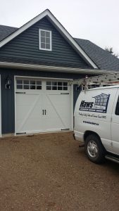 White Clopay Coachman door design 22 with rectangular grille and decorative hardware, variant 2