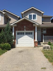 White Clopay Classic long panel door with rectangular grille window insert