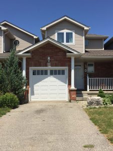 White Clopay Classic door with elegant short panel and rectangular grille window