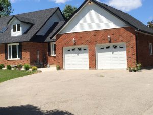 White Clopay Classic garage door with elegant short panel and Sunset 503 window insert