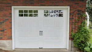 White Clopay Gallery door with elegant long panel, square grille and #16 step plate hardware