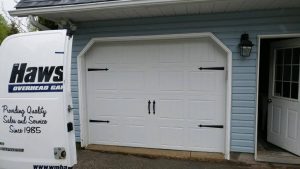 White Clopay Gallery door with elegant long panel and standard handles and hinges