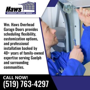 Technician installing overhead garage door hardware.