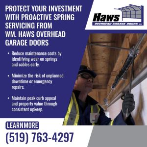 Technician inspecting and servicing garage door springs and cables for preventive maintenance